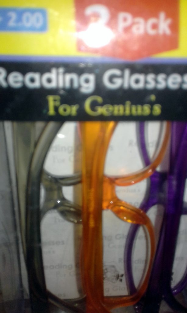 Photo of a three-pack of reading glasses labelled "For Genius's"